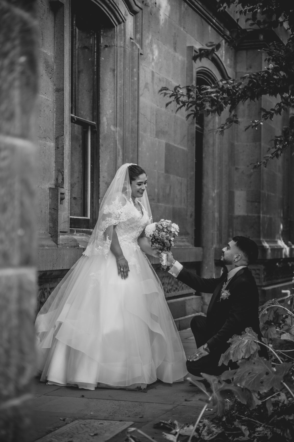 Gradient — B&W wedding candid, bride and groom on heritage steps