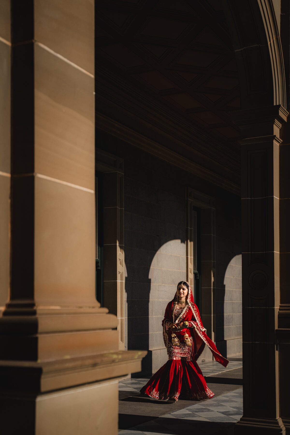 Gradient — bride in deep archway bokeh, cinematic light