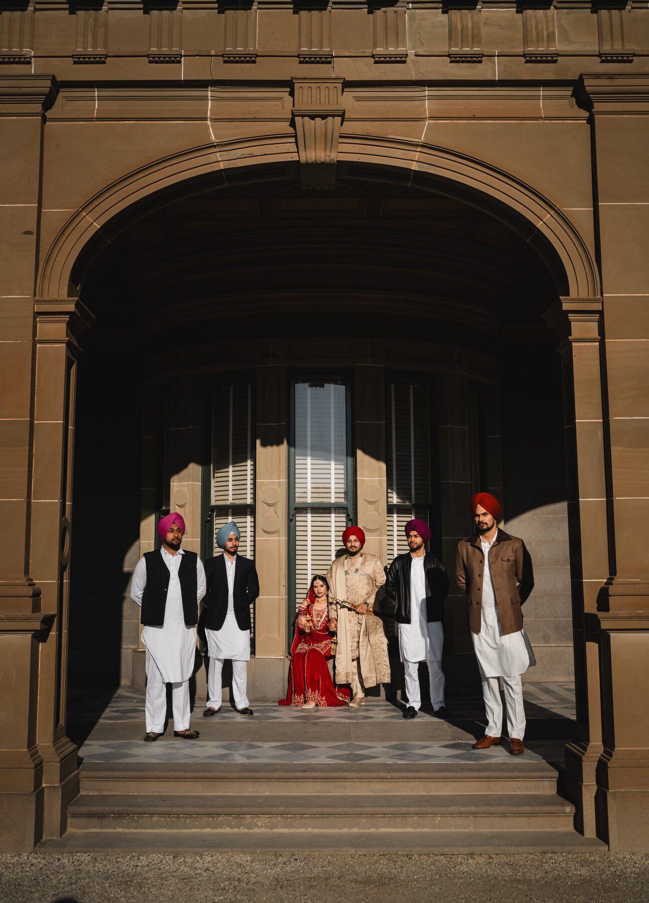 Gradient — wedding party in grand stone archway, Melbourne heritage